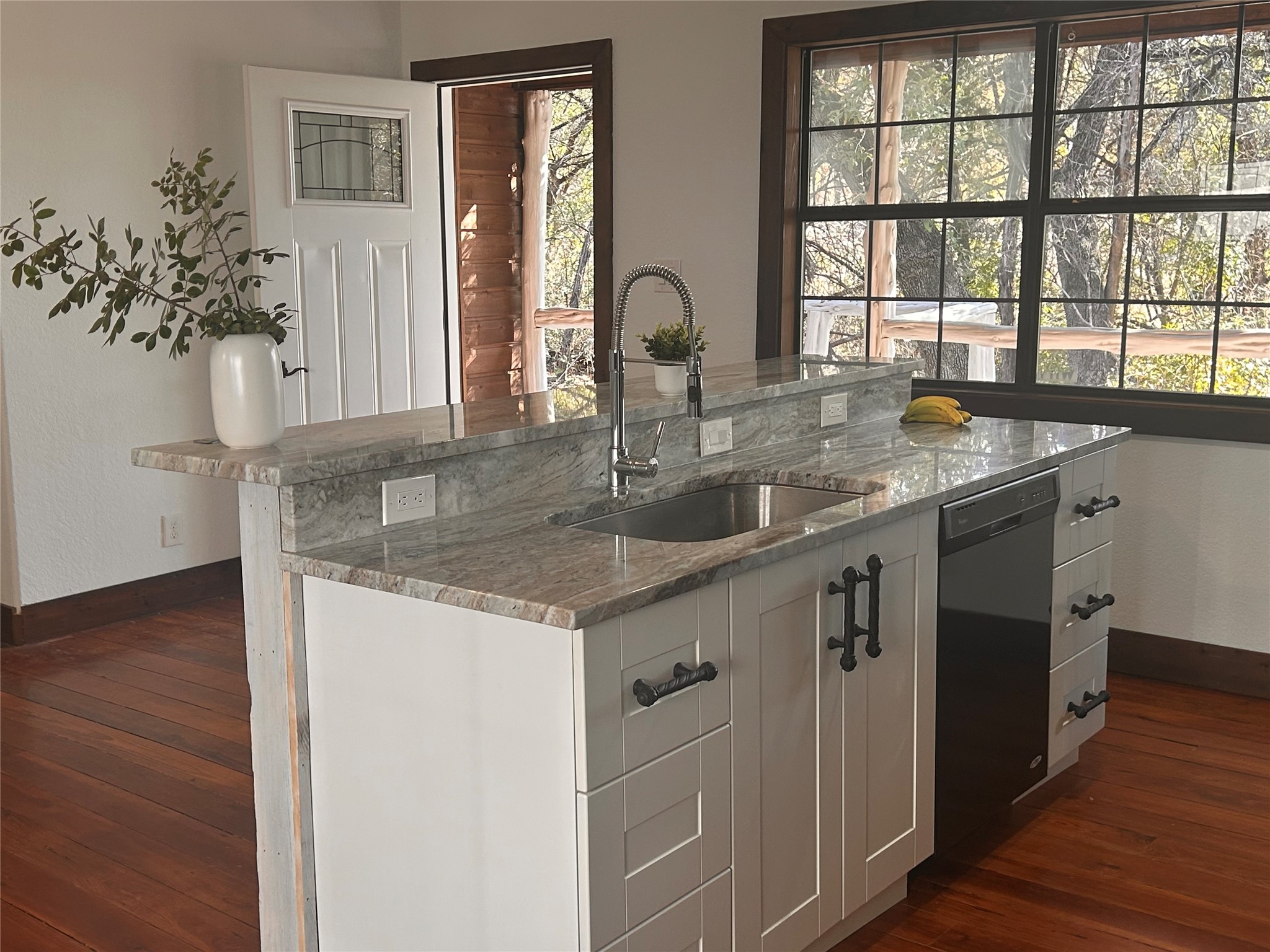 15104 Texas Street Austin, TX 78734 - Photo 3 of 18 a kitchen with stainless steel appliances granite countertop a sink a stove and wooden floors