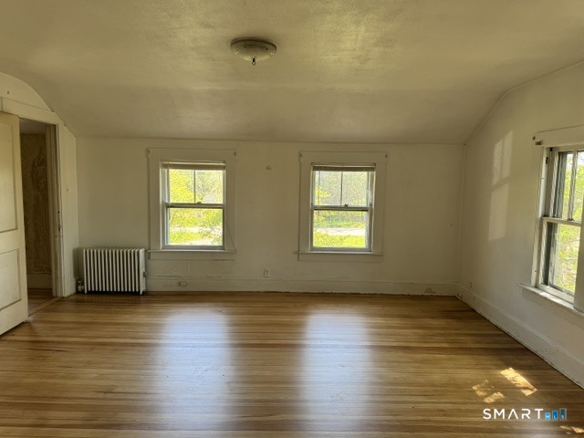 408 Huntington Road Scotland, CT 06264 - Photo 10 of 10 an empty room with wooden floor and windows