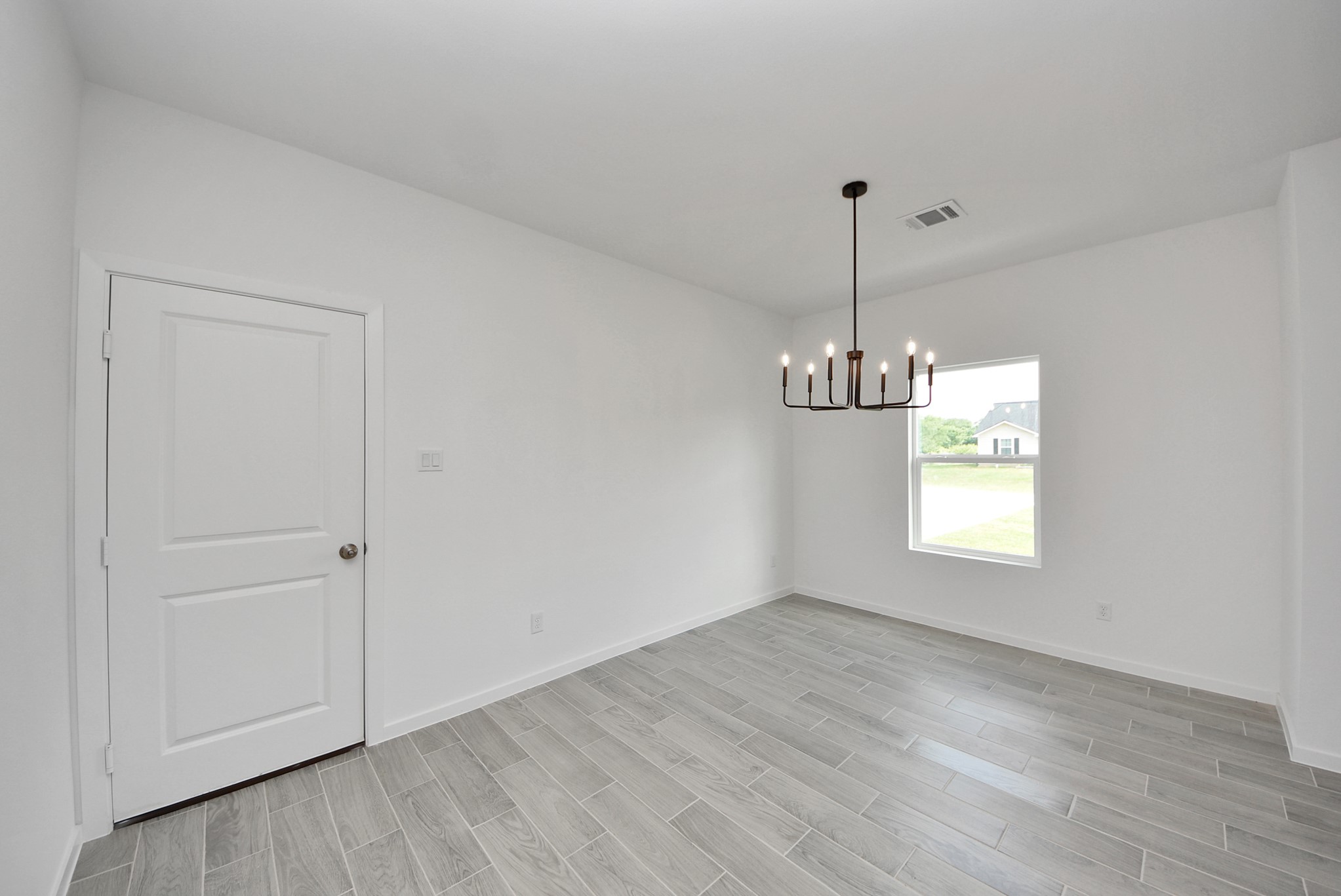 211 19th Street Hempstead, TX 77445 - Photo 19 of 32 Bright dining area featuring modern light fixture.