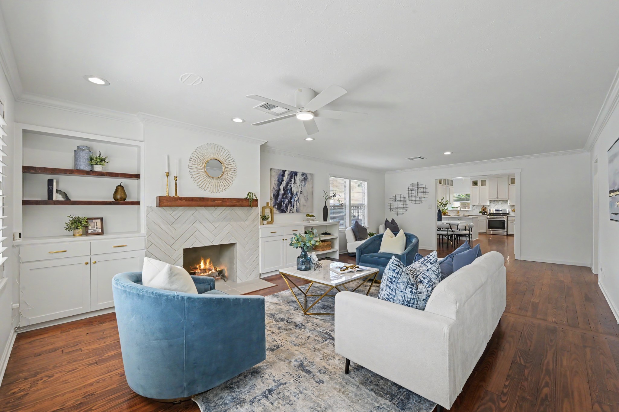 807 Key Street Houston, TX 77009 - Photo 6 of 27 Spacious living area featuring warm hardwood floors, recessed lighting, built-in cabinetry and shelving, and a beautifully updated fireplace.