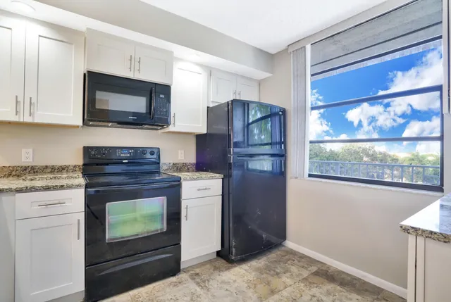 a view of a kitchen with a sink and a cabinet
