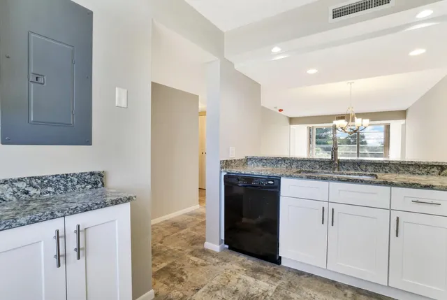 a kitchen with stainless steel appliances granite countertop a refrigerator stove and sink