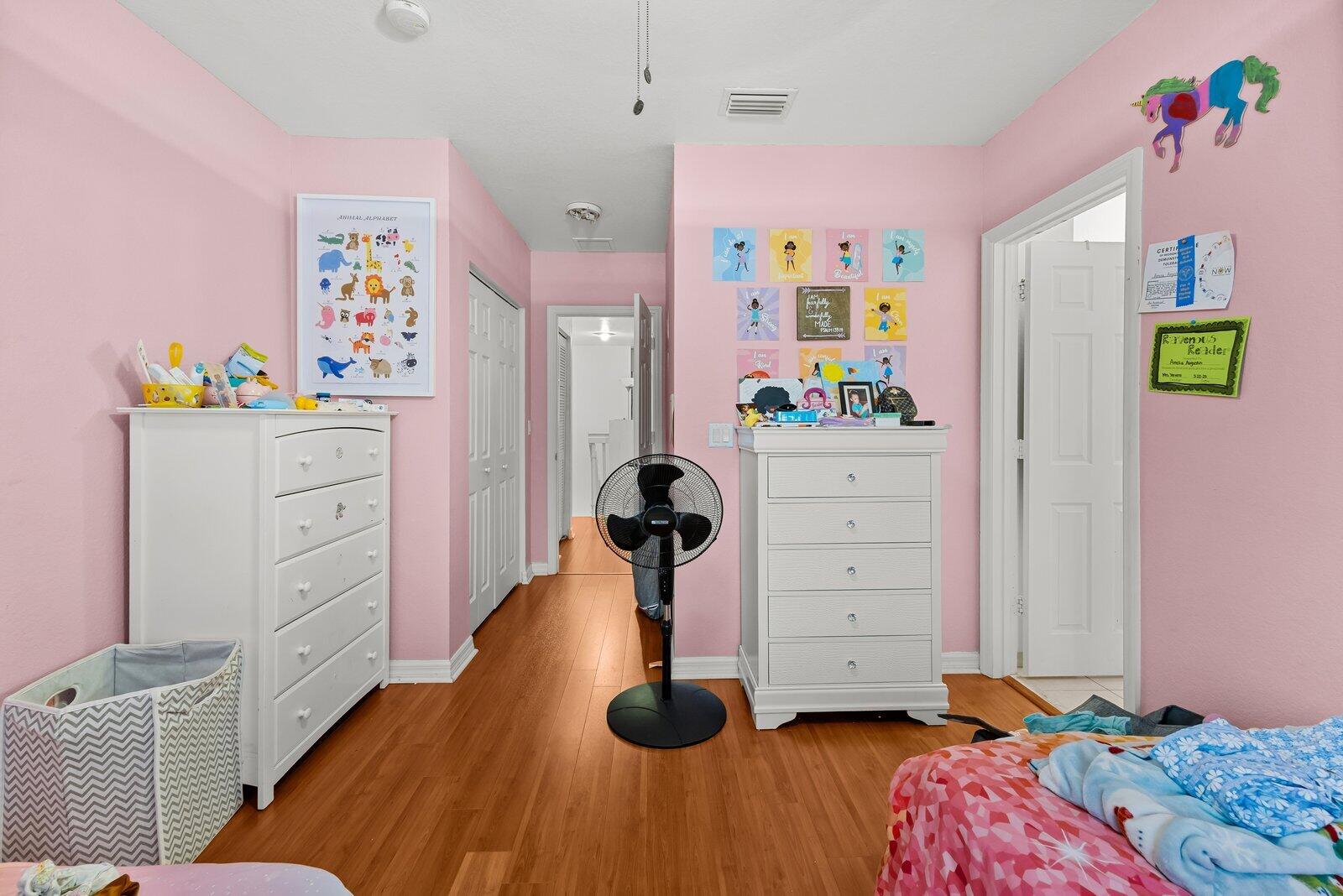 1955 Alamanda Way Riviera Beach, FL 33404 - Photo 12 of 25 a bedroom with a bed and a dresser