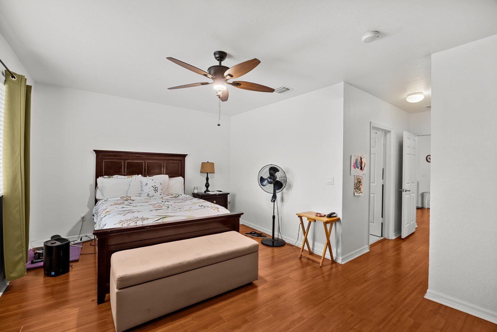1955 Alamanda Way Riviera Beach, FL 33404 - Photo 15 of 25 a bedroom with a bed and a chandelier