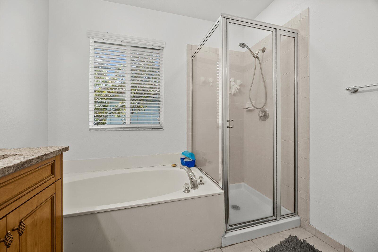 1955 Alamanda Way Riviera Beach, FL 33404 - Photo 17 of 25 a bathroom with a tub a sink and a shower