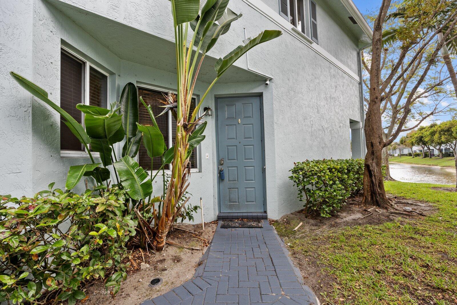 1955 Alamanda Way Riviera Beach, FL 33404 - Photo 2 of 25 a front view of a house with a yard