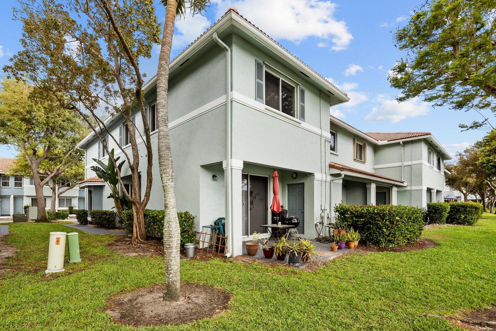 1955 Alamanda Way Riviera Beach, FL 33404 - Photo 22 of 25 front view of a house with a yard