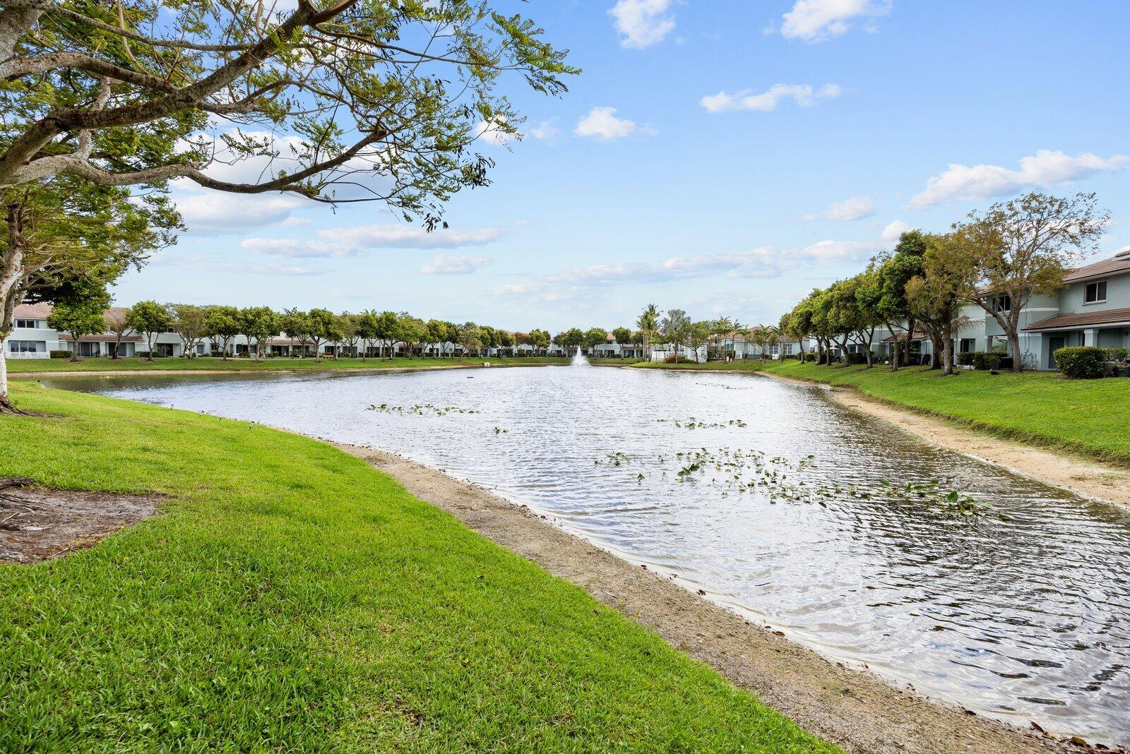 1955 Alamanda Way Riviera Beach, FL 33404 - Photo 23 of 25 a view of a lake with houses in the back