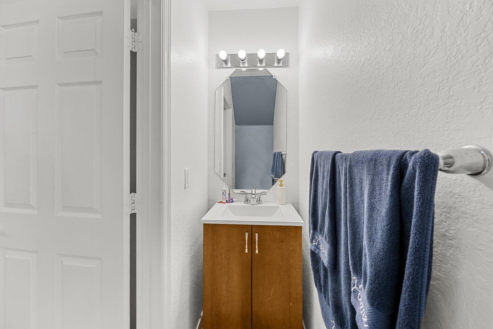 1955 Alamanda Way Riviera Beach, FL 33404 - Photo 9 of 25 a bathroom with a granite countertop sink and a mirror