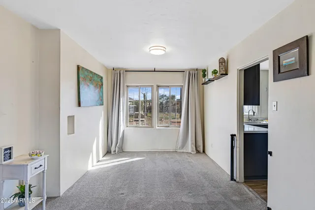 a view of a hallway with bathroom and front door