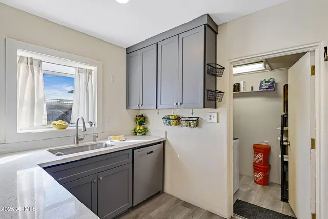 a kitchen with a refrigerator and a sink