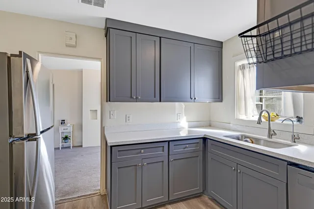 a kitchen with a sink and cabinets