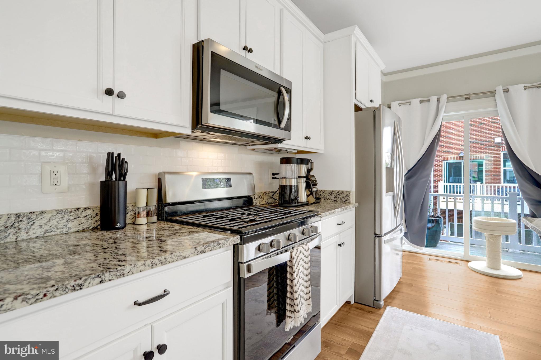 9180 Snowden Ashford Road Lorton, VA 22079 - Photo 9 of 28 a kitchen with stainless steel appliances granite countertop a stove a sink and a microwave