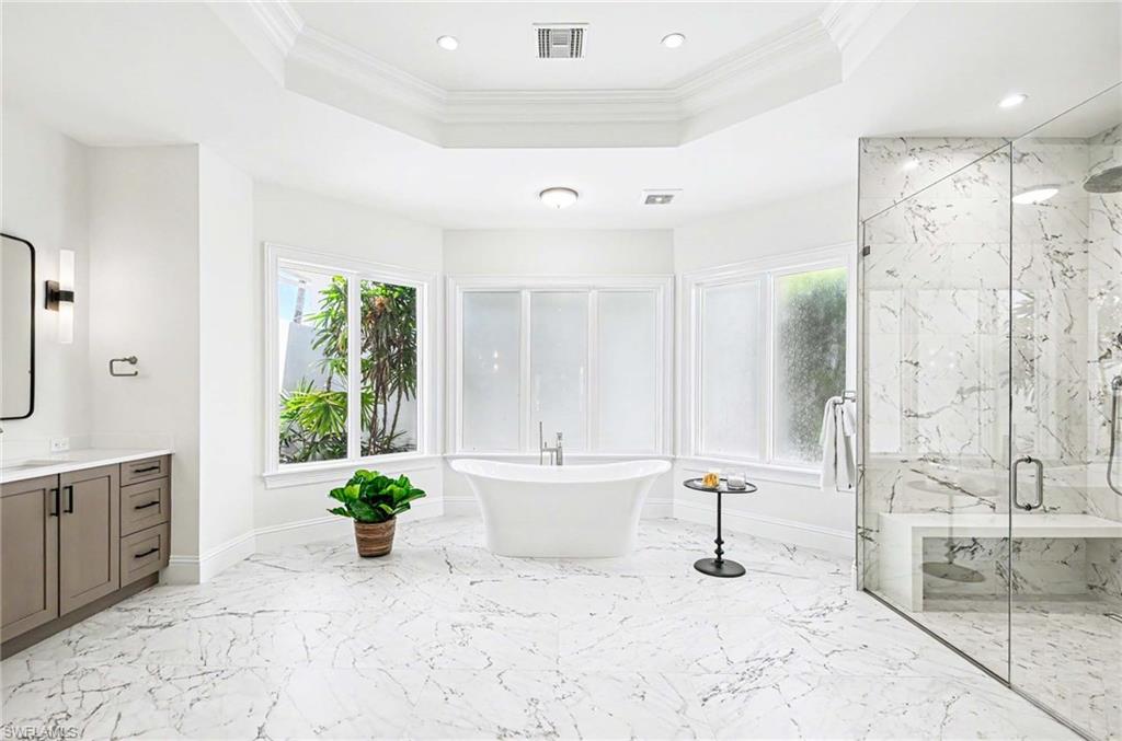 1888 6th Street South Naples, FL 34102 - Photo 23 of 37 a bathroom with a bathtub and a shower