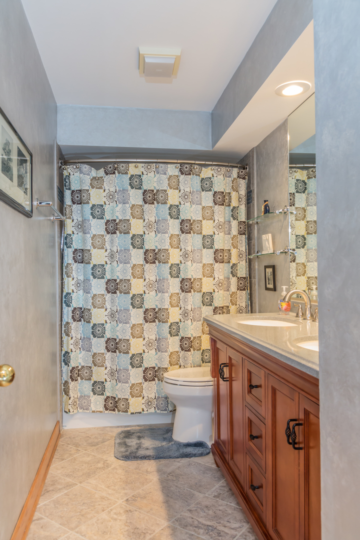 848 Kent Circle Bartlett, IL 60103 - Photo 13 of 23 a bathroom with a granite countertop sink a toilet and a shower