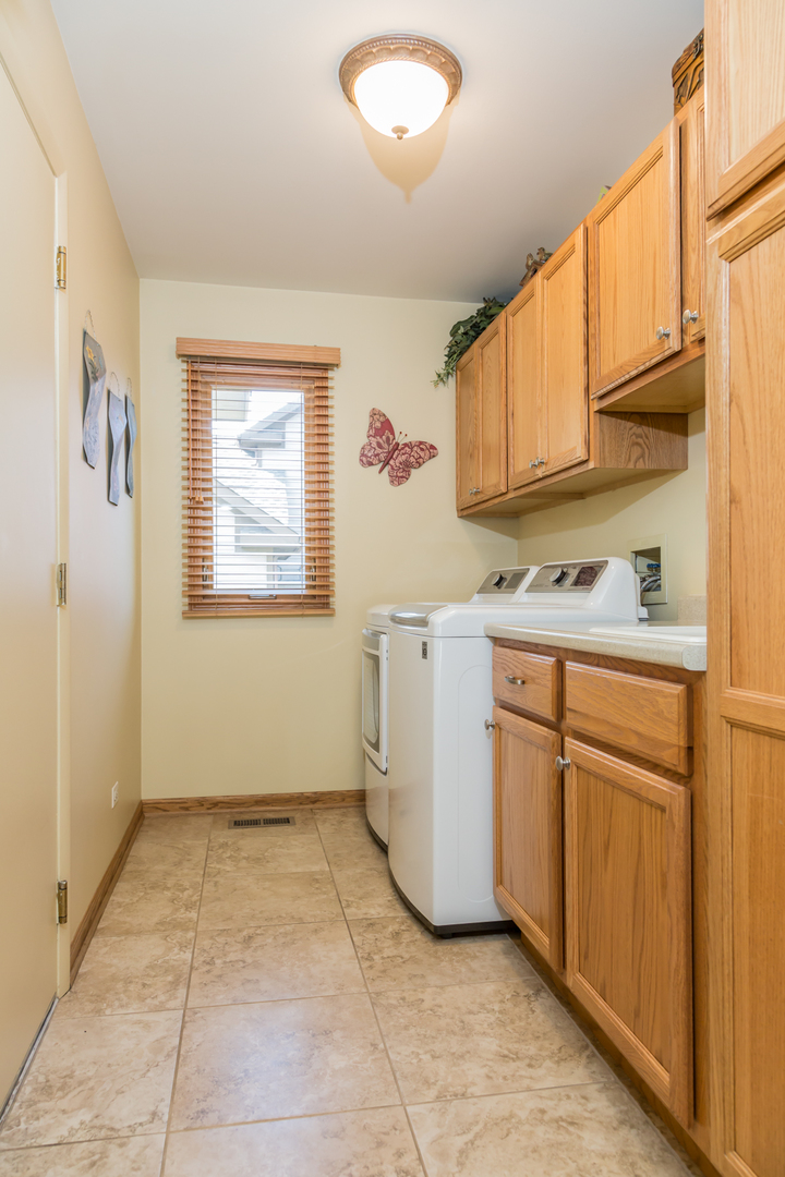 848 Kent Circle Bartlett, IL 60103 - Photo 5 of 23 a utility room with cabinets washer and dryer