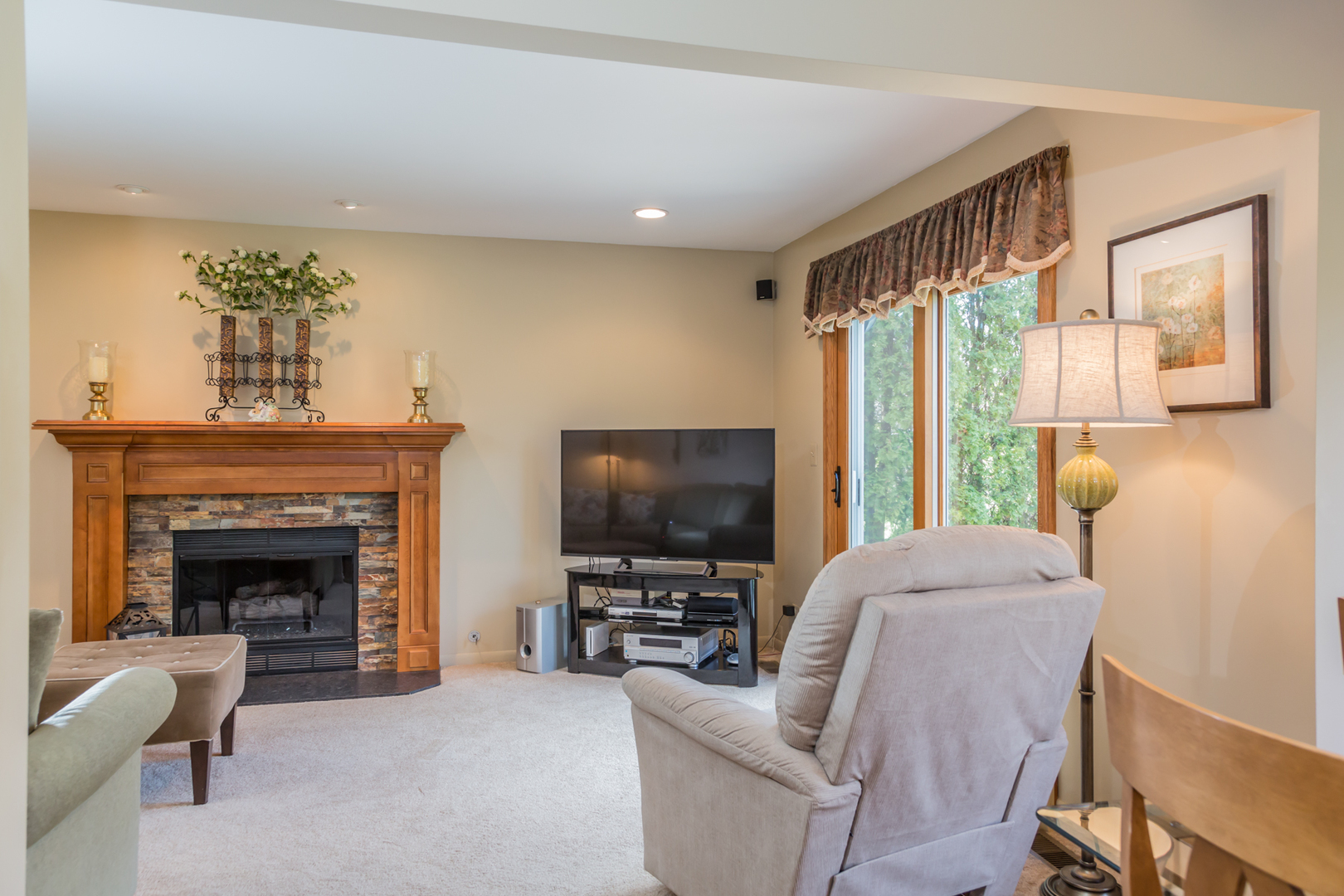 848 Kent Circle Bartlett, IL 60103 - Photo 7 of 23 a living room with furniture a flat screen tv and a fireplace