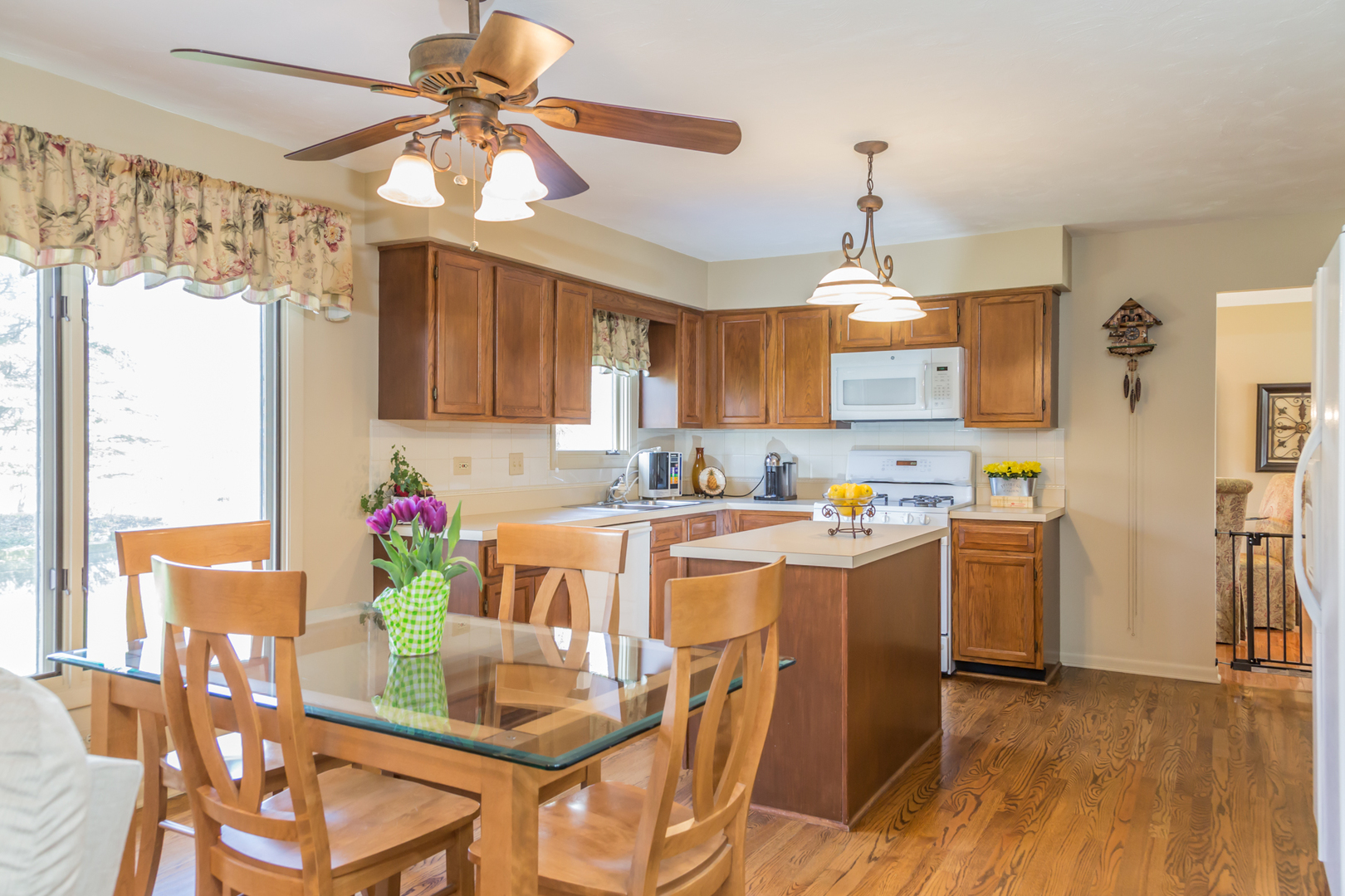 848 Kent Circle Bartlett, IL 60103 - Photo 8 of 23 a kitchen with stainless steel appliances kitchen island granite countertop a dining table chairs and white cabinets