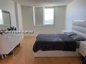 a spacious bedroom with a bed and a window