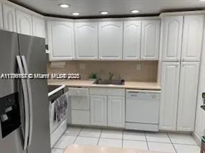 a kitchen with a refrigerator and cabinets