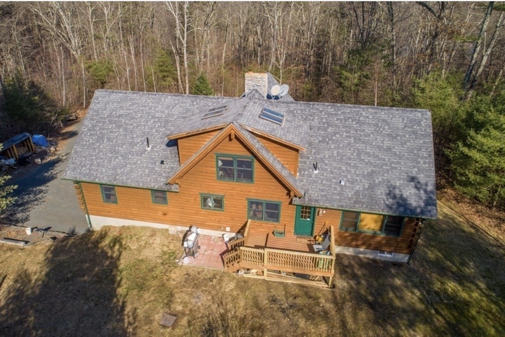 1854 Greenwich Road Hardwick, MA 01082 - Photo 6 of 42 an aerial view of a house with swimming pool and large trees