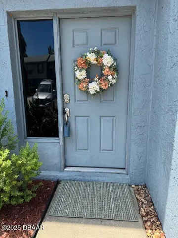 a view of a entryway door of the house and wooden floor