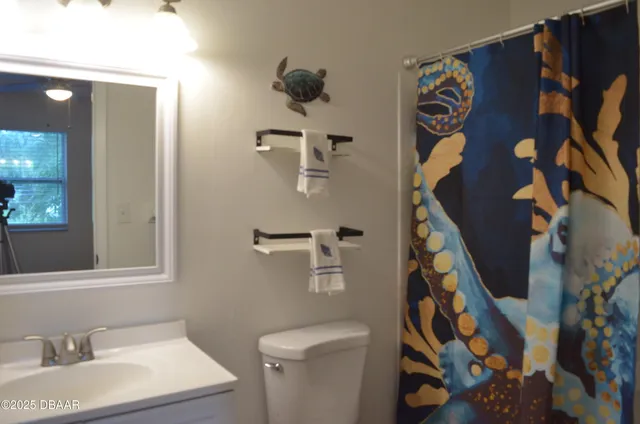 a bathroom with a sink and mirror with toilet