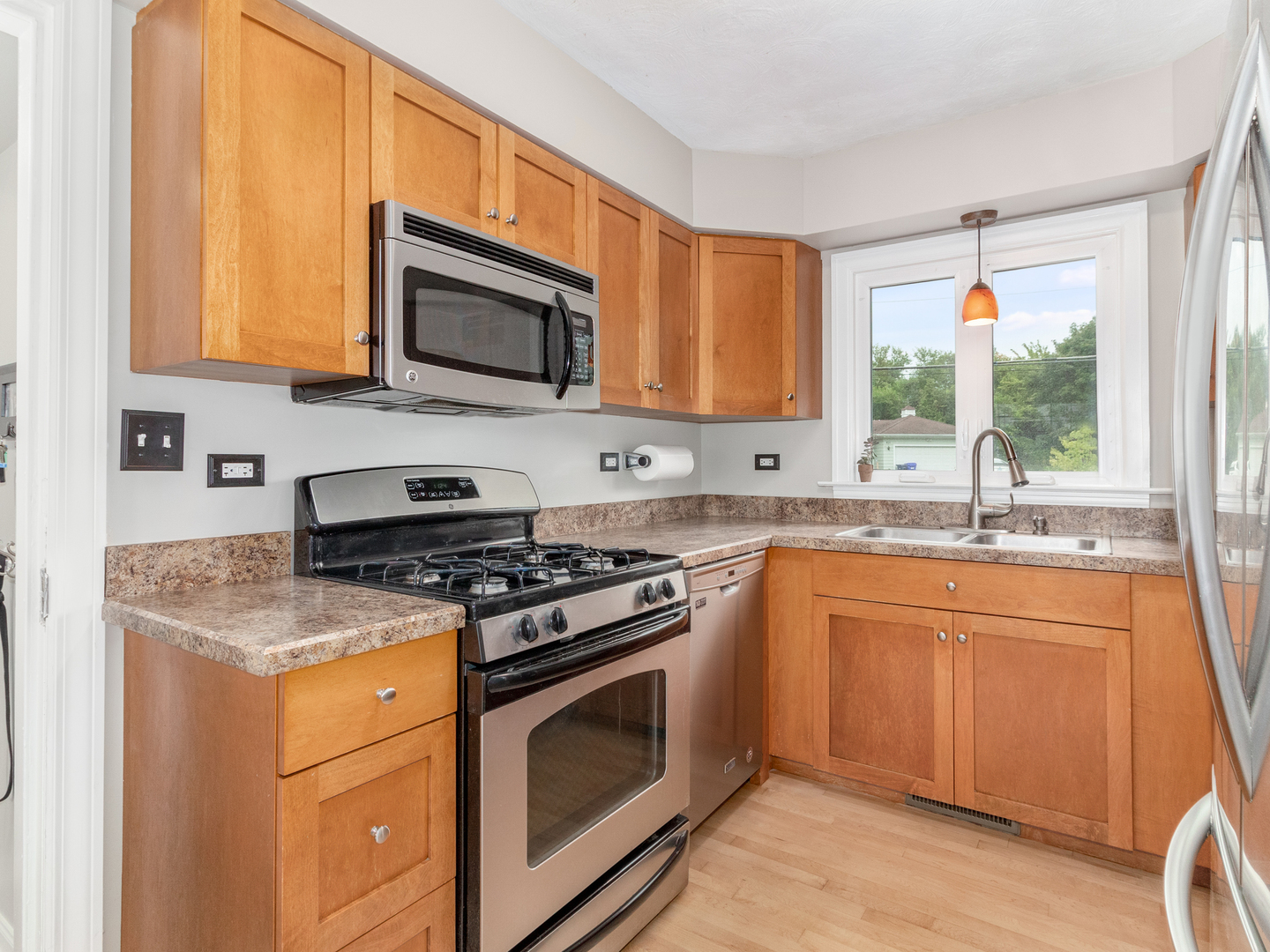 810 North Gary Avenue Wheaton, IL 60187 - Photo 17 of 36 a kitchen with stainless steel appliances granite countertop a sink a stove a microwave and wooden cabinets