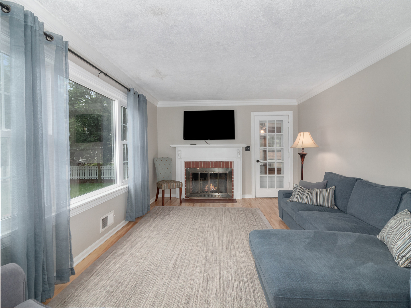 810 North Gary Avenue Wheaton, IL 60187 - Photo 9 of 36 a living room with furniture a fireplace and a flat screen tv