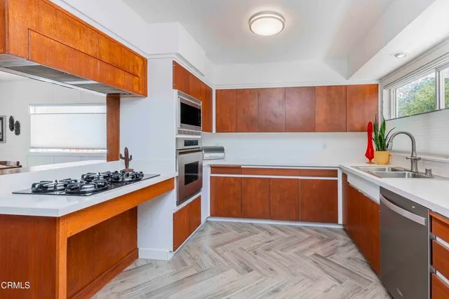 a kitchen with a sink cabinets and stainless steel appliances