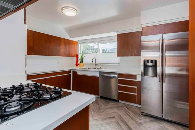 a kitchen with stainless steel appliances granite countertop a stove and a refrigerator