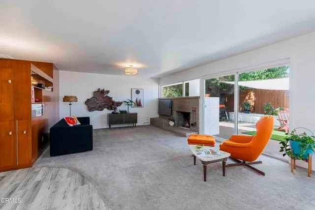 a view of a dining room with furniture and a chandelier