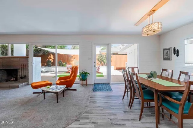 a living room with blue lights with wooden floor and furniture