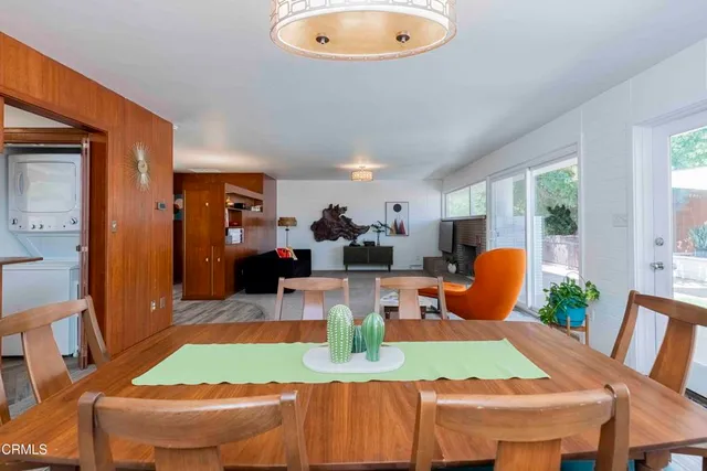 a view of a hallway with wooden floor and a bathroom