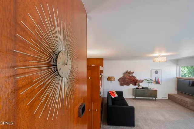 a view of a hallway with living room and furniture