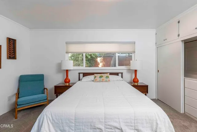 a room with wooden floor and mirror
