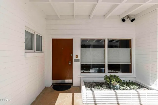 a view of hallway with a large window and wooden floor
