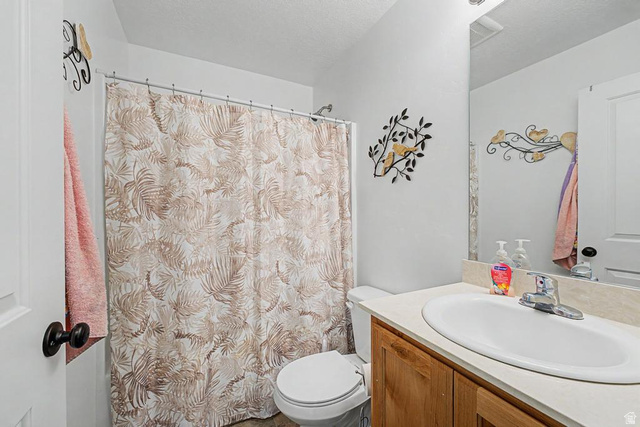 1692 South Windemere Road Santaquin, UT 84655 - Photo 11 of 23 Bathroom featuring a shower with a shower curtain, a toilet, a vanity with a laminate countertop, and a built-in mirror