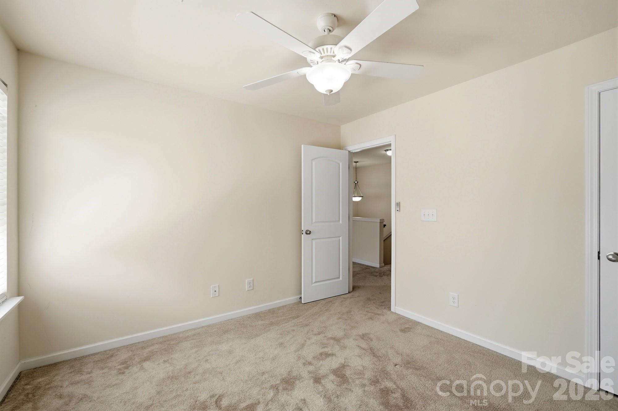 175 Limerick Road, Unit B Mooresville, NC 28115 - Photo 24 of 30 an empty room with a ceiling fan and a window