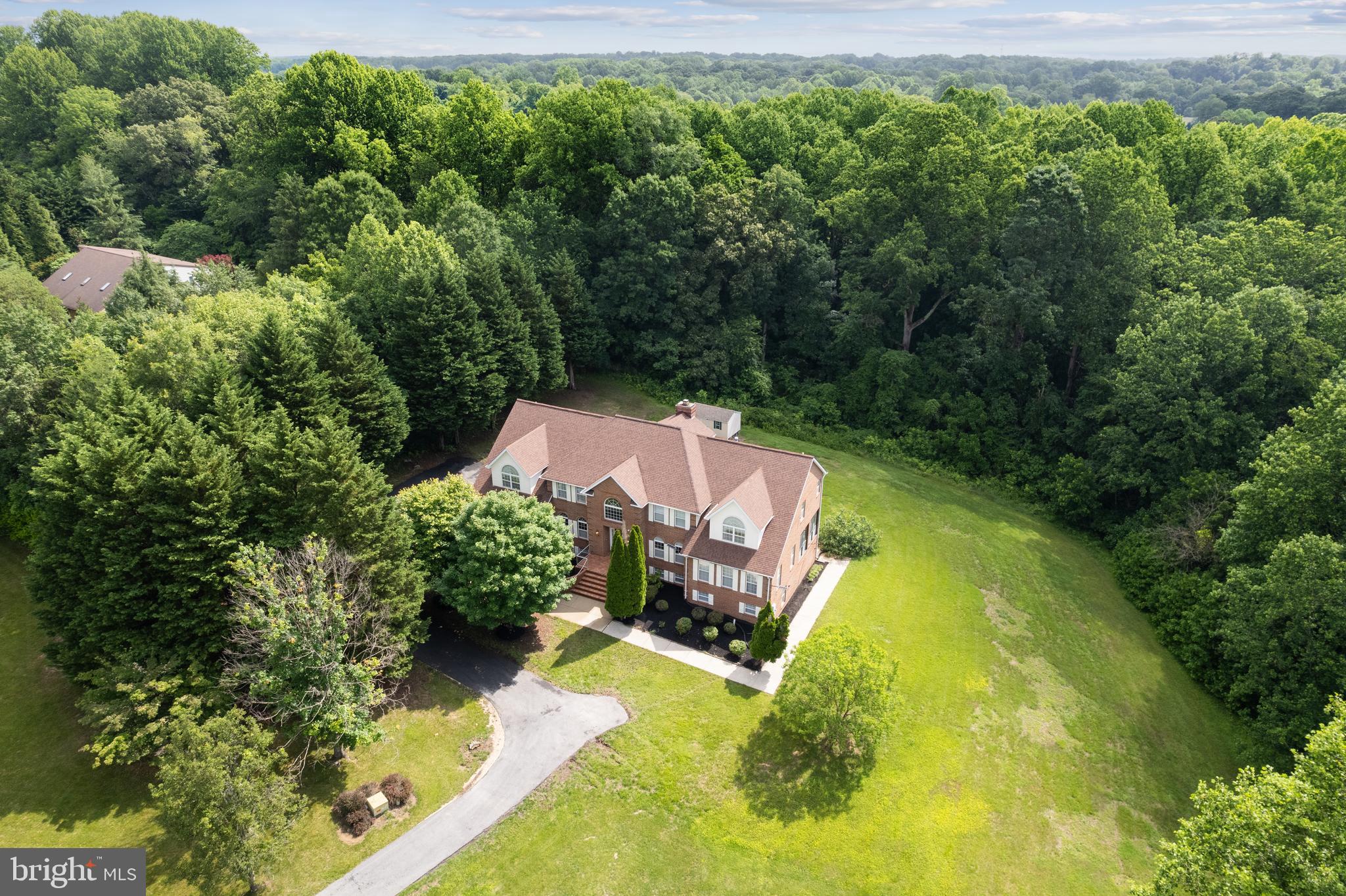 an aerial view of a house with a yard basket ball court and outdoor seating