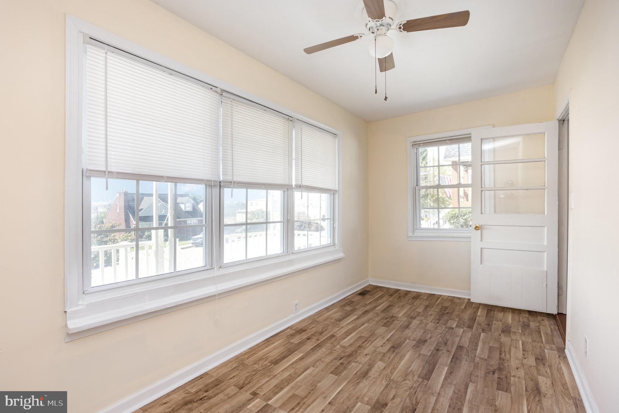 505 47th Street Baltimore, MD 21224 - Photo 11 of 41 a view of an empty room with a window and wooden floor