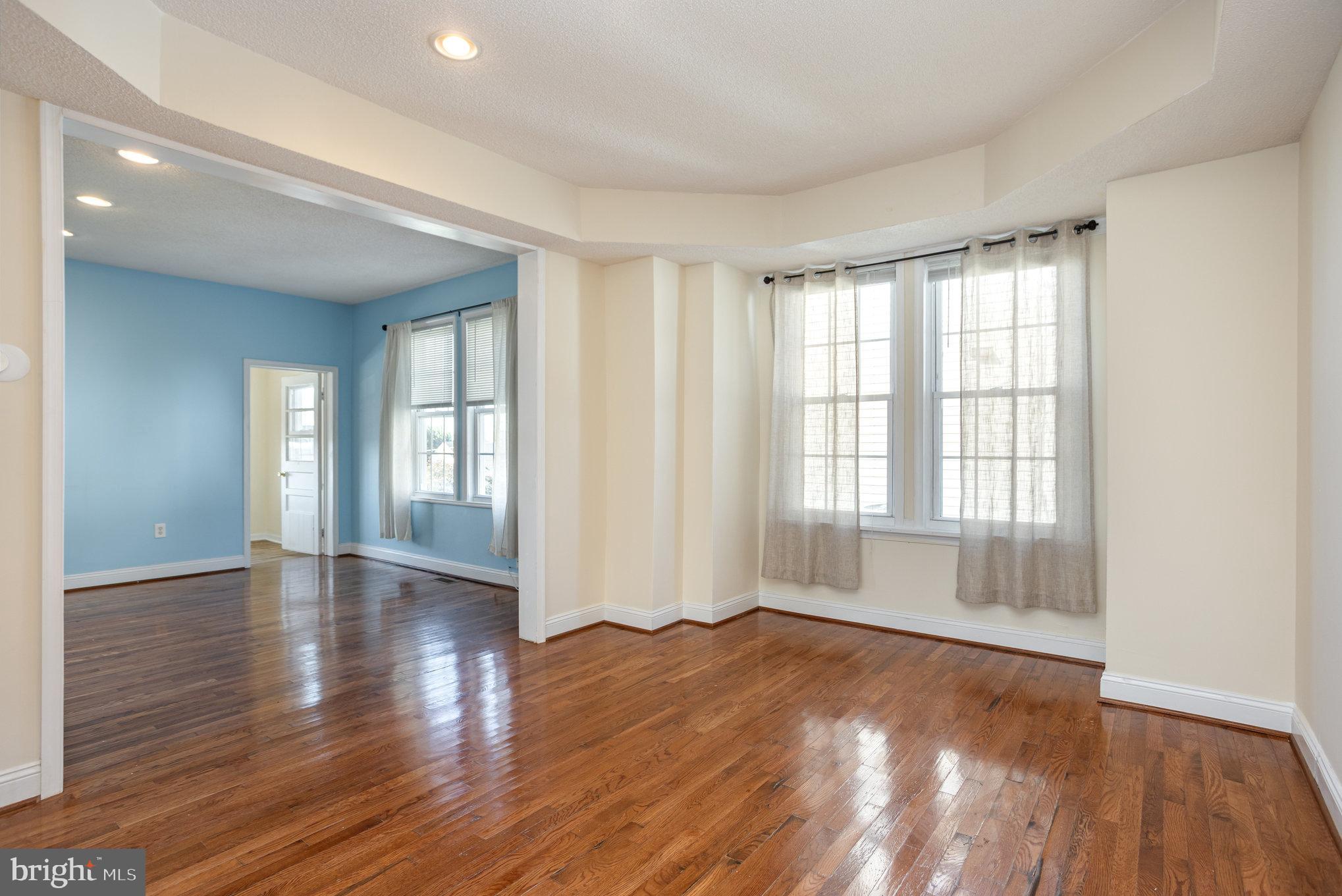 505 47th Street Baltimore, MD 21224 - Photo 13 of 41 an empty room with wooden floor and windows