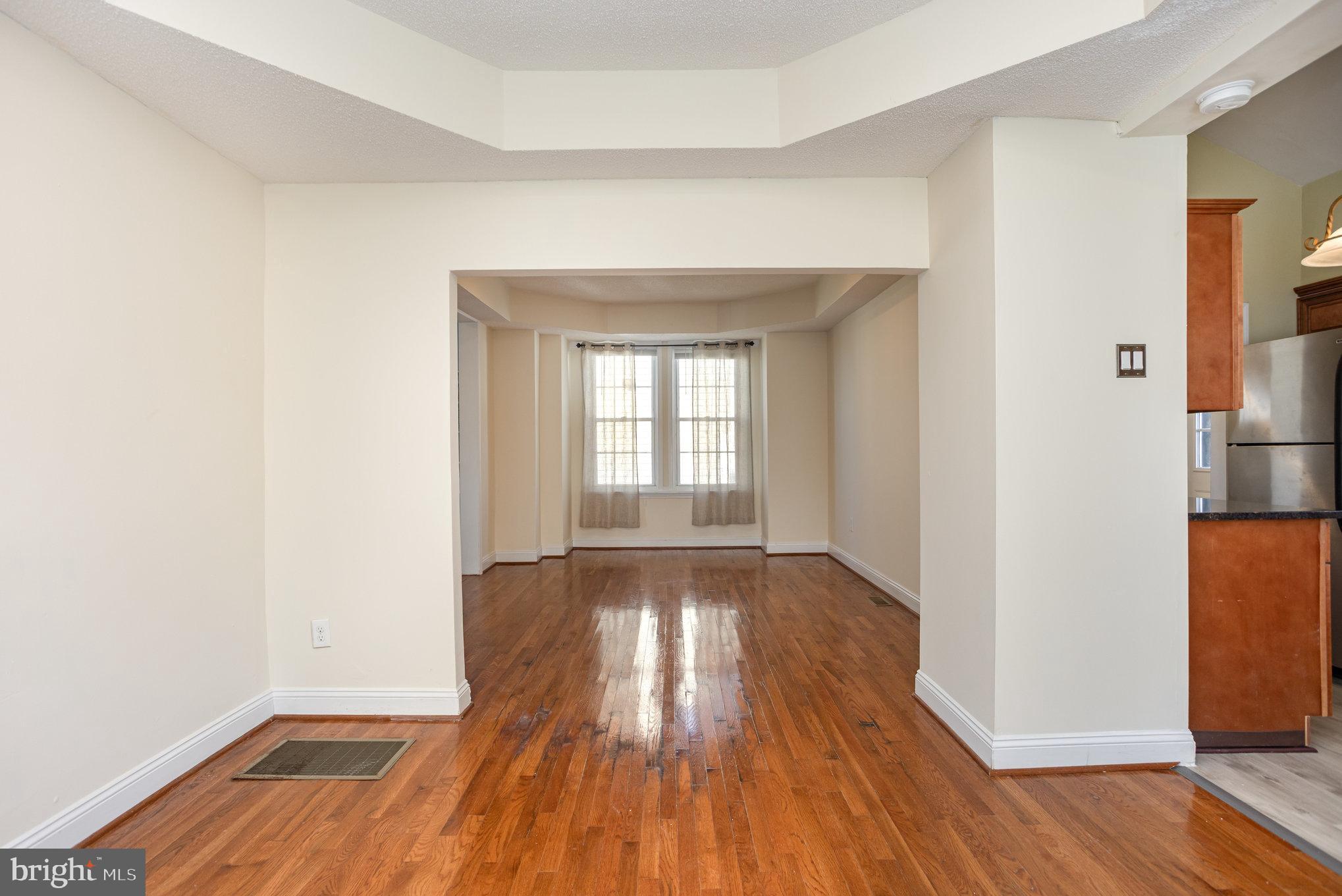 505 47th Street Baltimore, MD 21224 - Photo 15 of 41 an empty room with wooden floor and a window