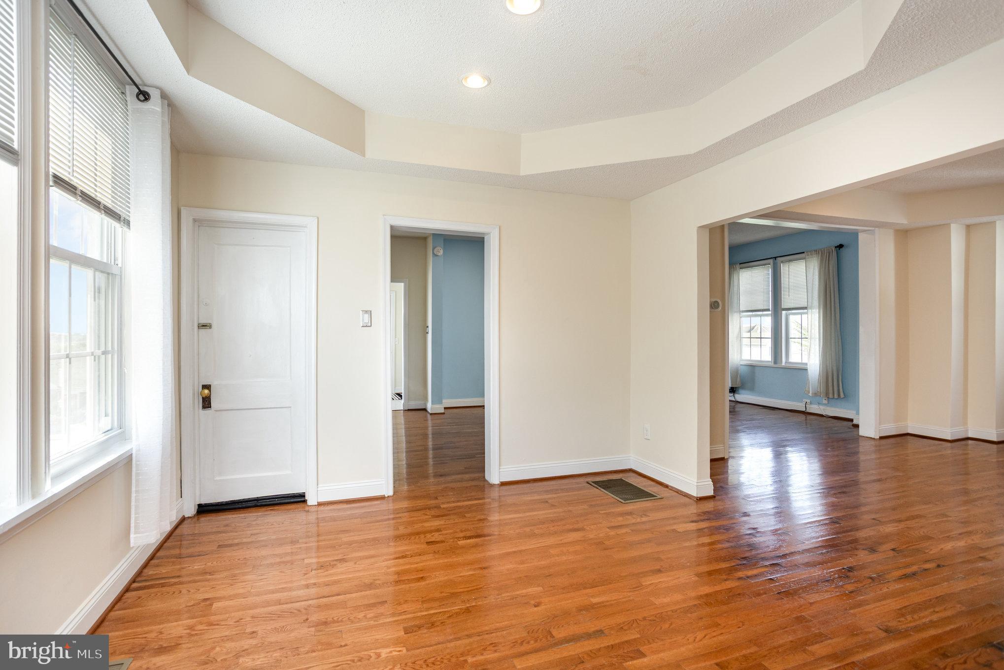 505 47th Street Baltimore, MD 21224 - Photo 18 of 41 an empty room with wooden floor and windows