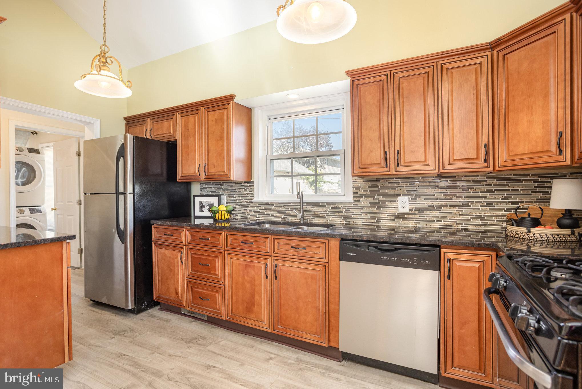 505 47th Street Baltimore, MD 21224 - Photo 20 of 41 a kitchen with stainless steel appliances granite countertop a refrigerator and a sink
