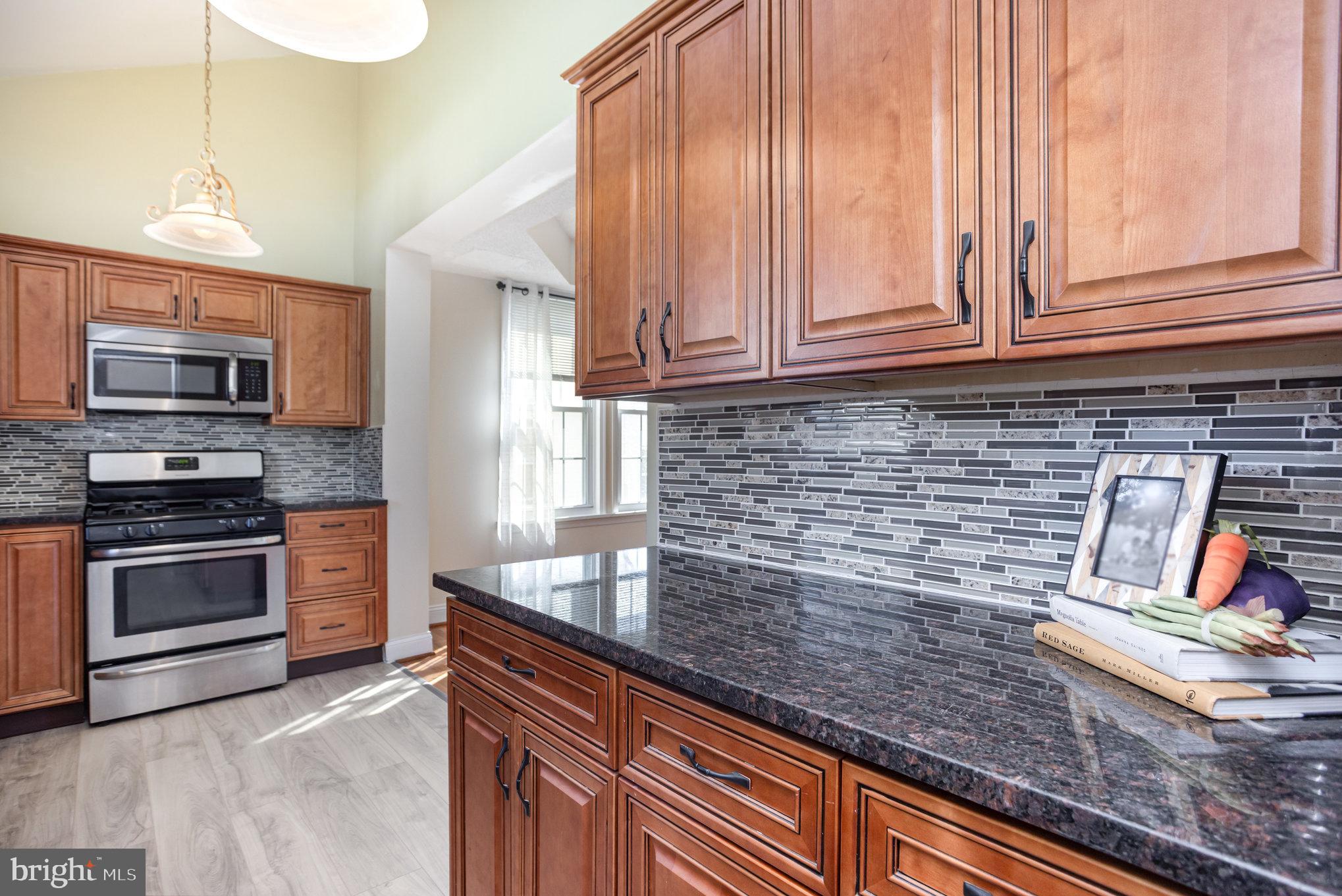 505 47th Street Baltimore, MD 21224 - Photo 22 of 41 a kitchen with granite countertop cabinets stainless steel appliances and a counter space