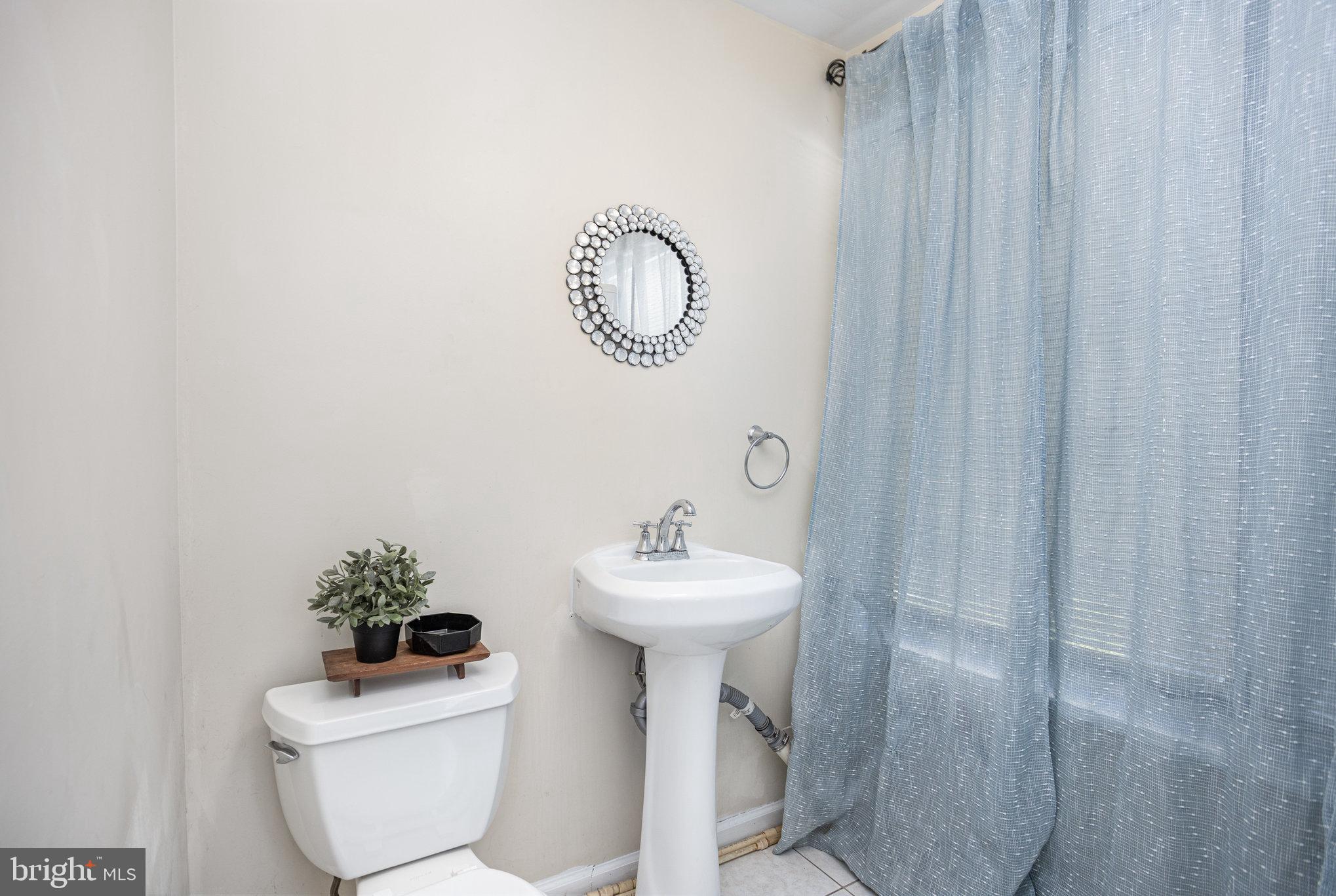 505 47th Street Baltimore, MD 21224 - Photo 24 of 41 a bathroom with a sink toilet and a mirror