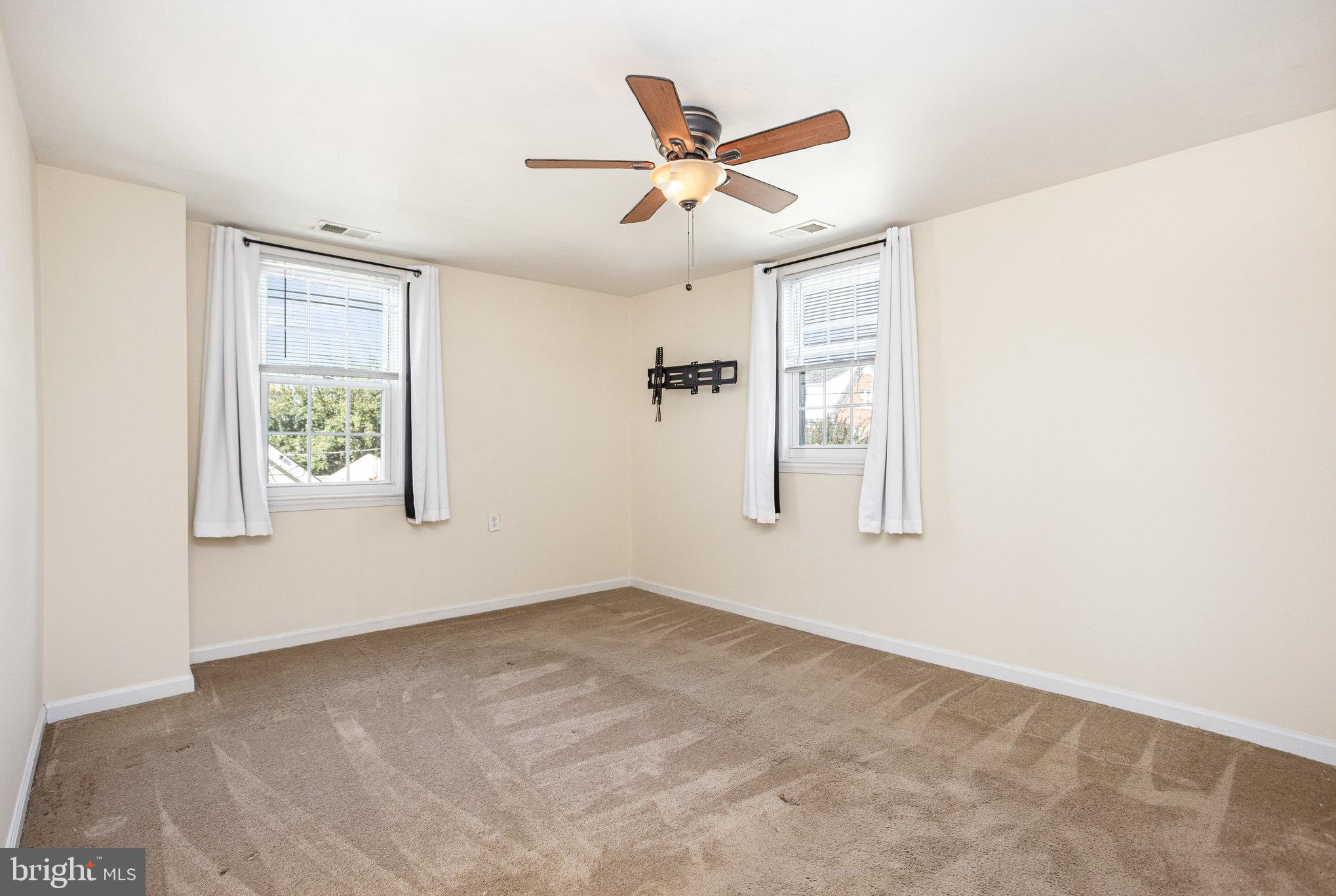 505 47th Street Baltimore, MD 21224 - Photo 26 of 41 an empty room with windows and ceiling fan