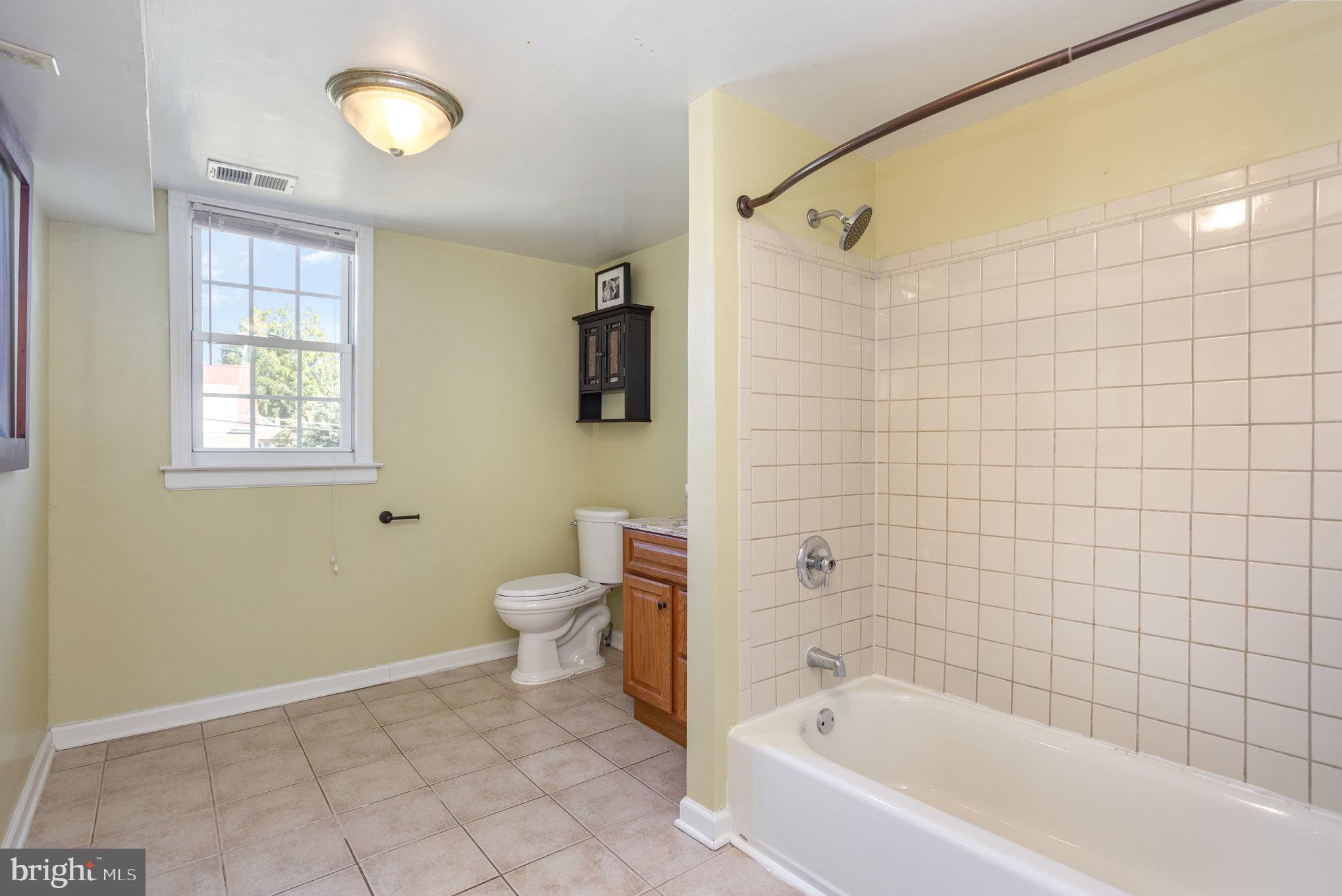 505 47th Street Baltimore, MD 21224 - Photo 28 of 41 a bathroom with a bathtub and a shower