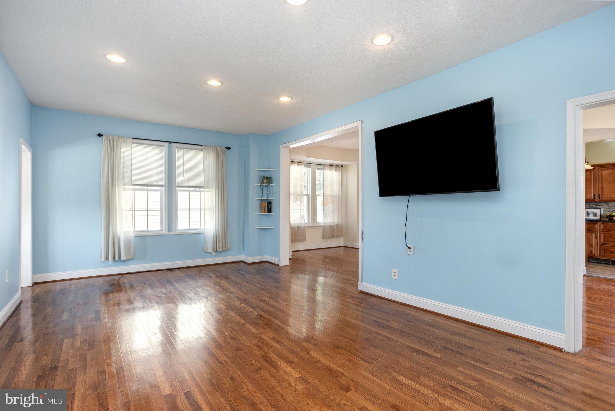 505 47th Street Baltimore, MD 21224 - Photo 6 of 41 an empty room with wooden floor and windows
